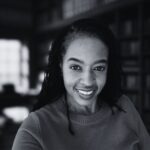 Black-and-white portrait of Lauren Lane smiling, an author and essayist focused on reflections about leadership, systems, timing, and unseen growth.